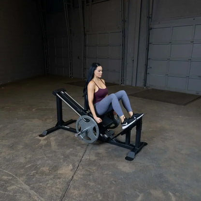Frau trainiert auf Beinpresse im Fitnessstudio – Krafttraining mit Gewichten