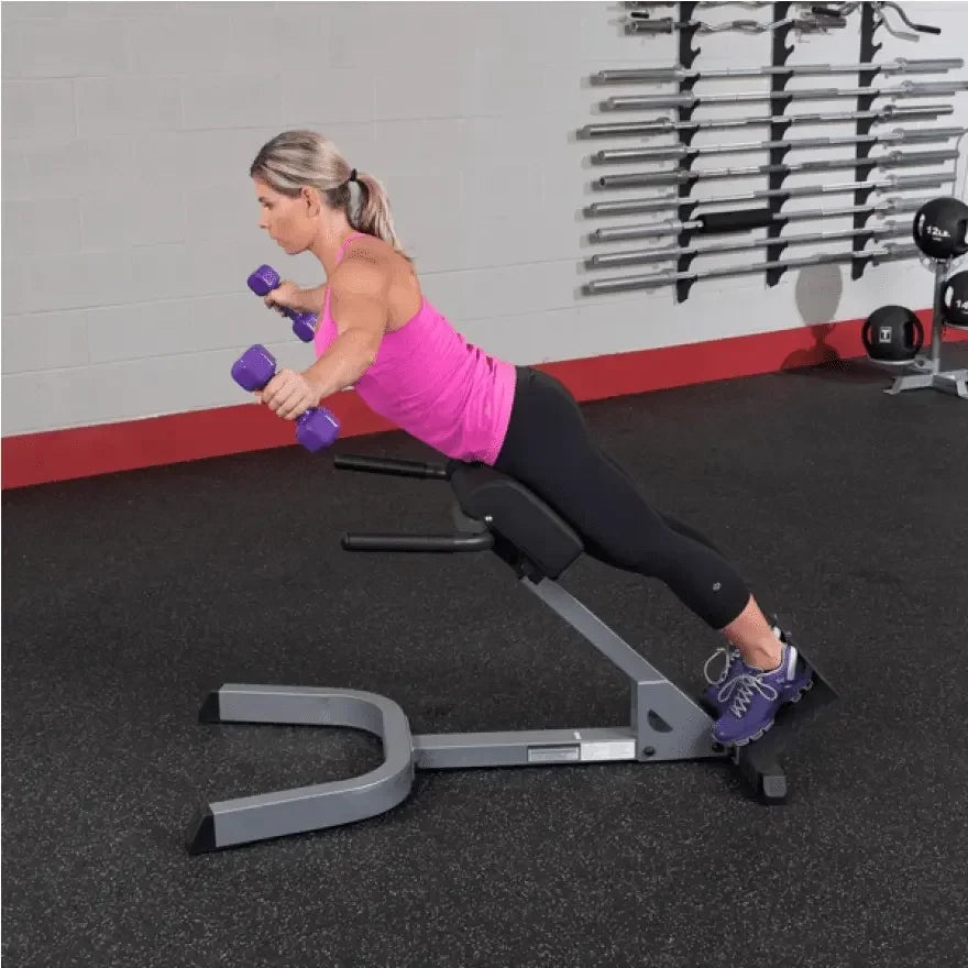 Frau trainiert mit Hanteln auf schräger Bank im Fitnessstudio – Krafttraining für Homegym & Studio