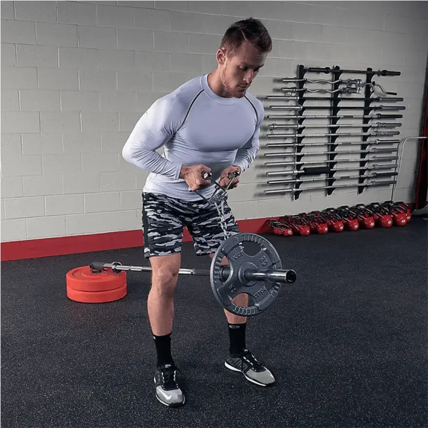 Mann trainiert mit Hantel und Ketten im Fitnessstudio – Kraftsport Equipment für Homegym & Studio