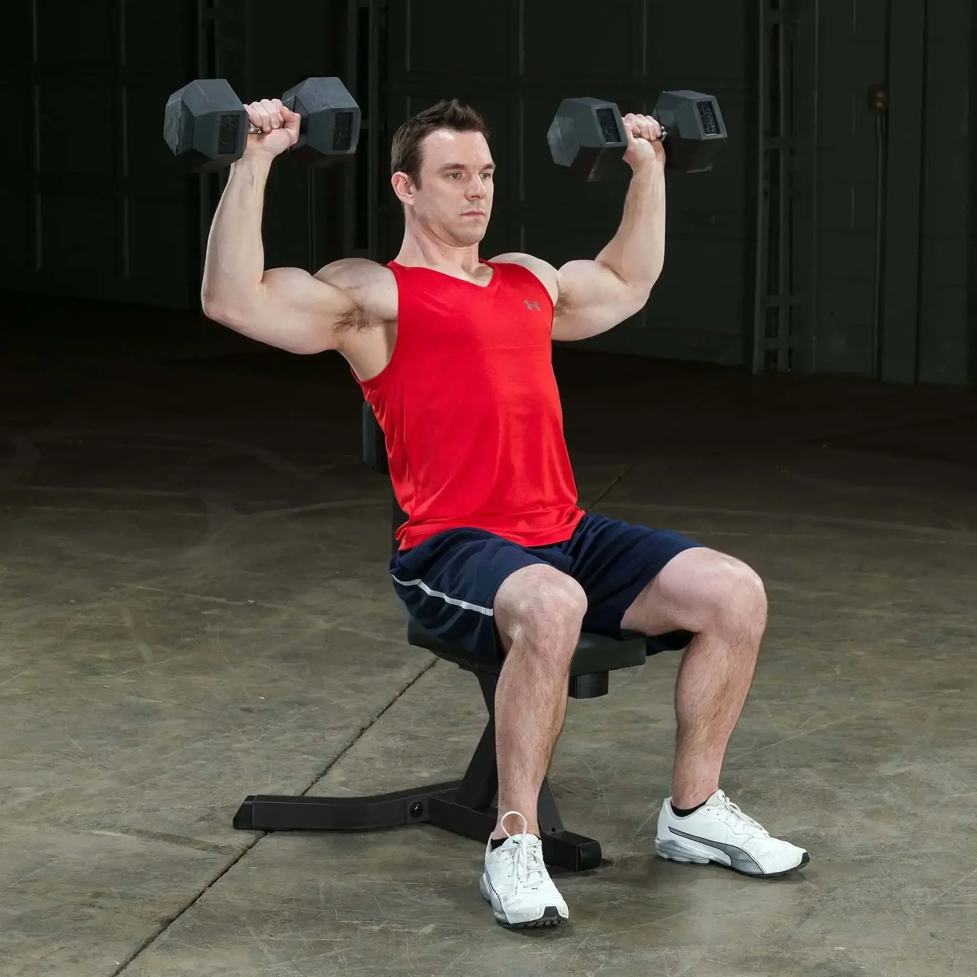 Mann trainiert mit Hanteln auf Hantelbank – Kraftsport & Fitness Equipment