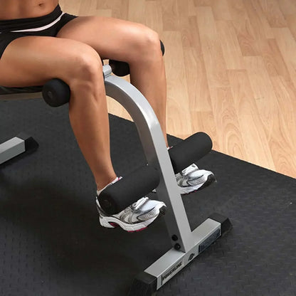 Mann trainiert Bauchmuskeln auf Fitnessbank mit Beinhalterung im Homegym